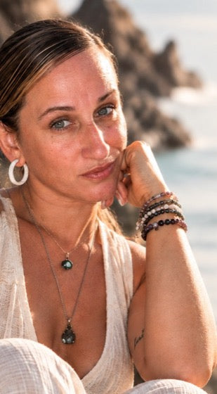 Meghan seated by the sea